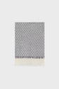 A folded rectangular foulard en coton with a blue and white geometric diamond motif bleu, featuring short fringe on one edge and a wide white border at the bottom. The textile exudes un style bohème and is displayed against a plain light background.