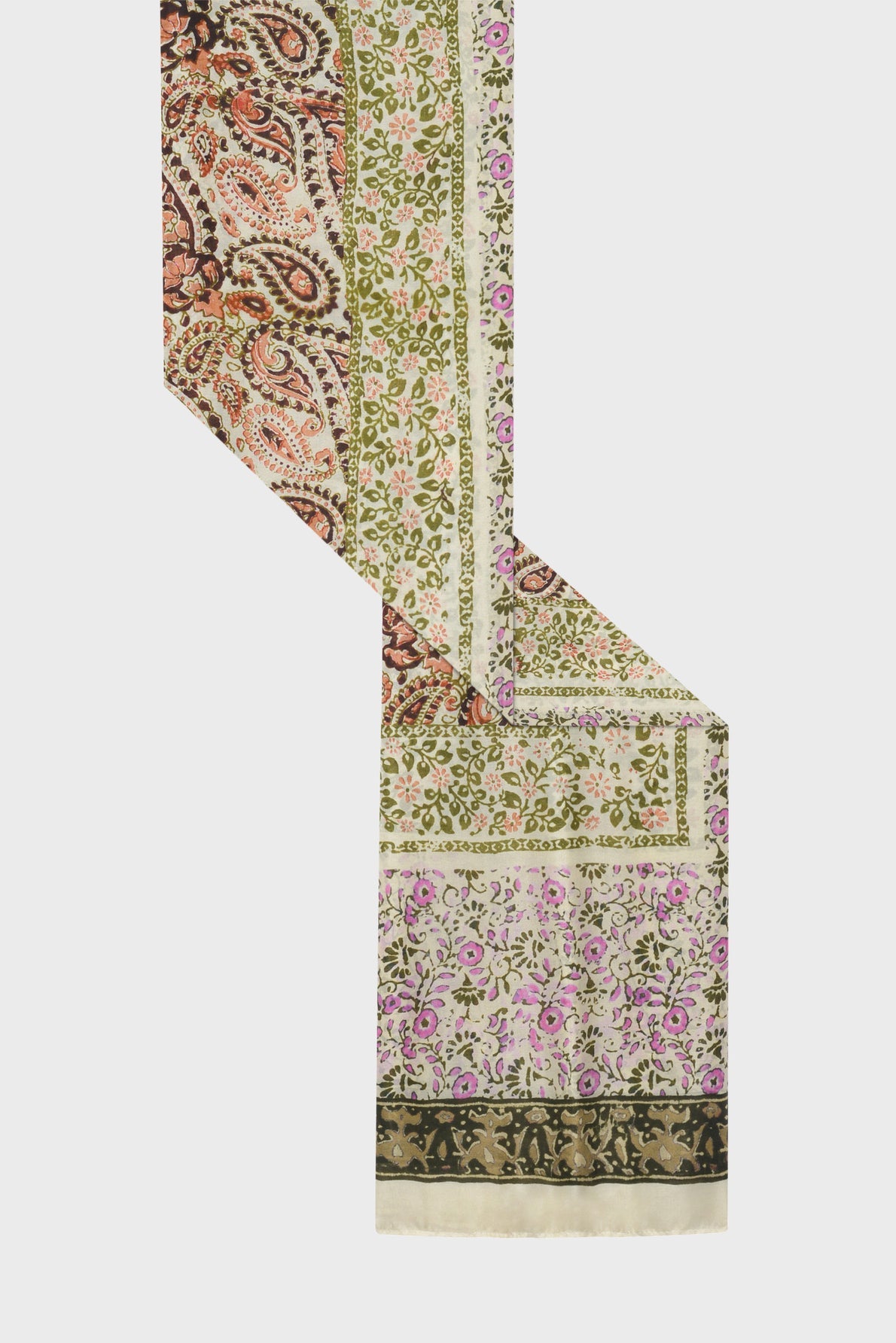 A fabric scarf with intricate imprimé floral and paisley patterns in green, pink, black, and orange on a cream background, displayed diagonally on a white surface—perfect for those who appreciate the elegance of a foulard indien.