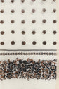 White fabric featuring a pattern of small brown and black flowers in rows, with a dense border of larger floral designs along the bottom edge, reminiscent of an élégante étole florale such as the étole Daphné crafted in coton et soie.