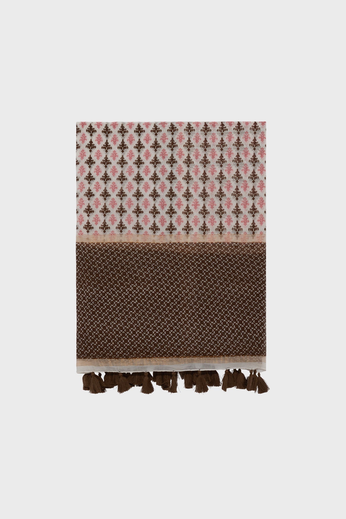 A folded foulard Dalma crafted from coton et soie displays pink and brown motifs géométriques on top, a solid brown woven section below, and brown tassels along the bottom edge, set against a plain white background.