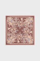 A carré en soie featuring a pink border and a detailed motif floral paisley pattern in pink, yellow, and blue on a rich burgundy background.