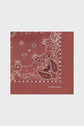 A square, reddish-brown foulard coton with a white paisley and floral pattern, and the text GERARD DAREL printed in small white letters in one corner. This imprimé bandana adds a touch of timeless style to any ensemble.