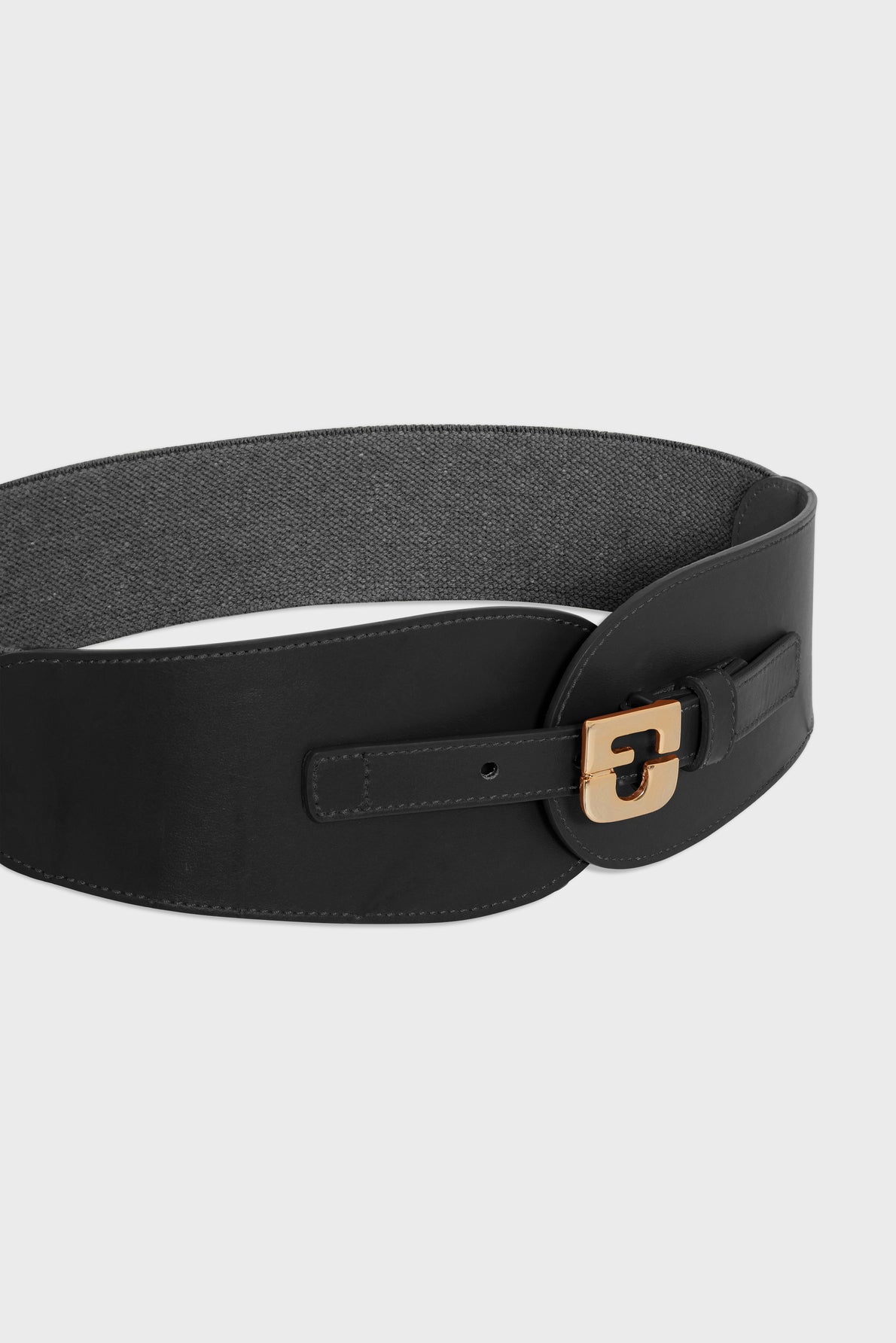 A wide black belt with a gold rectangular buckle and dark stitching, reminiscent of a ceinture Olympe, is displayed against a plain light gray background.