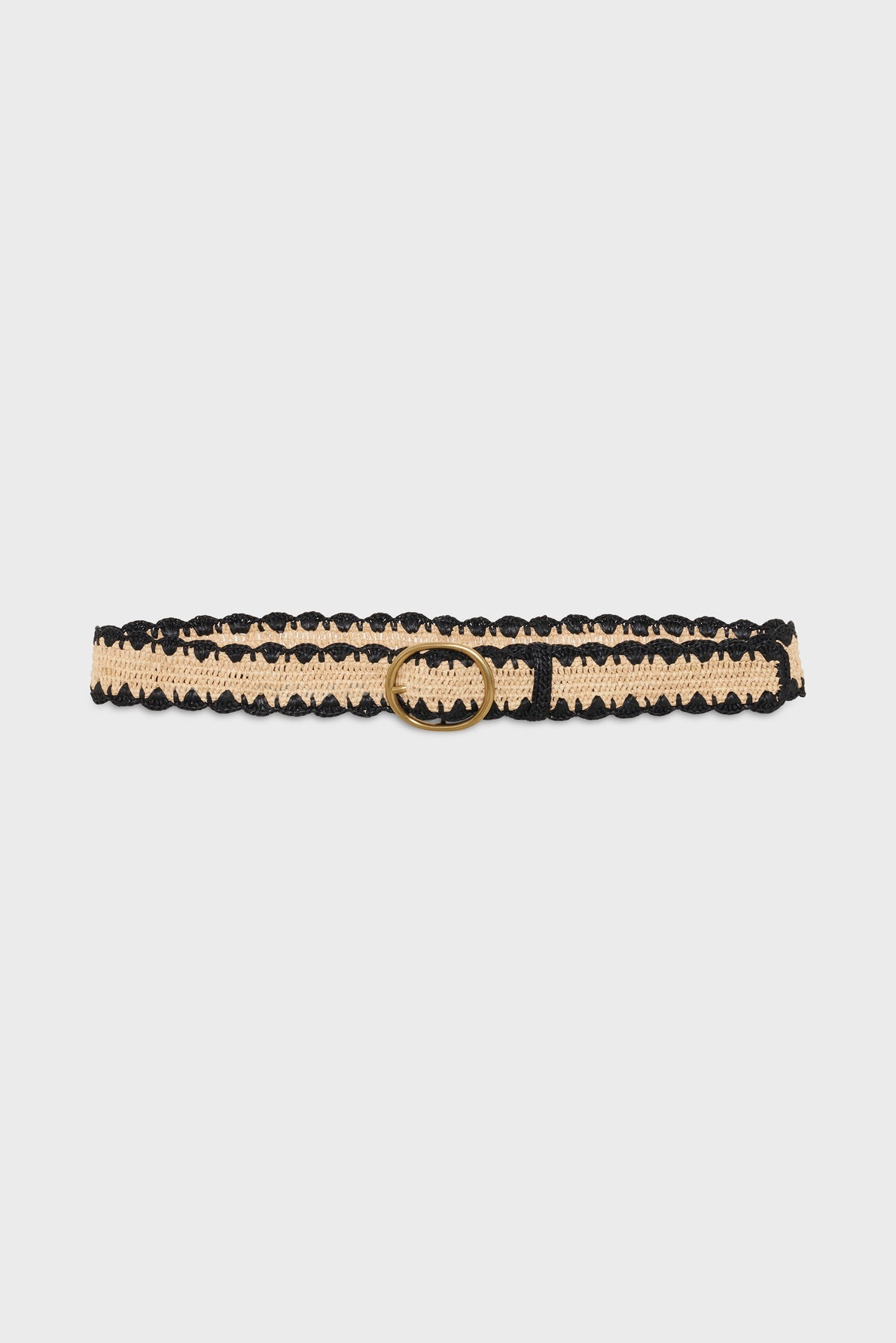 A beige and black lace ceinture artisanale with a gold round buckle is displayed against a plain white background.