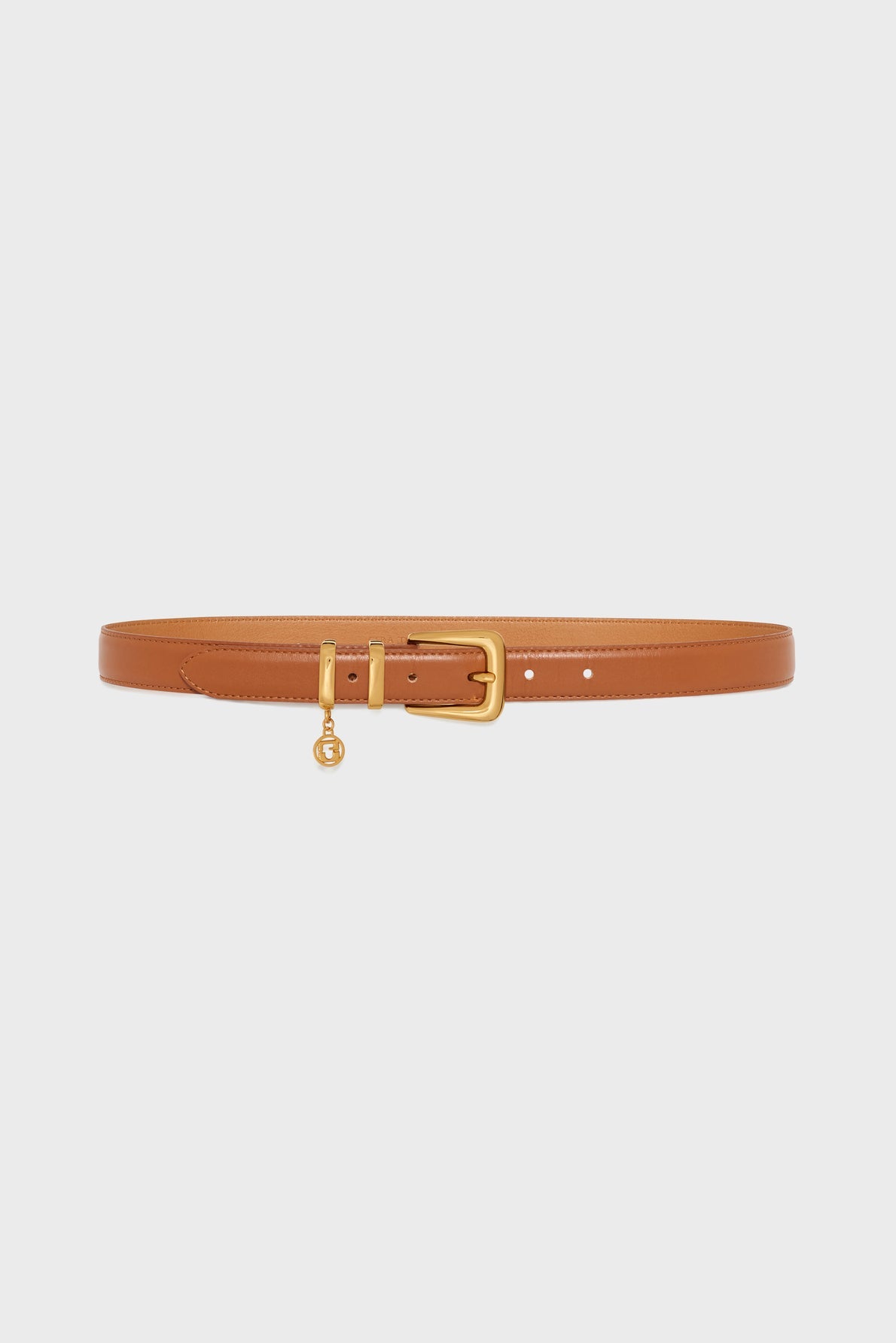A tan leather belt with a gold rectangular buckle and a small gold charm hanging from the buckle, this ceinture élégante by Gerard Darel is displayed on a plain white background.