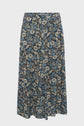 A jupe midi fluide with a blue, beige, and white motif floral featuring small daisies, set against a dark background.