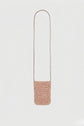 A small, rectangular, woven raphia crossbody bag with a long brown cuir strap is centered on a plain white background, serving perfectly as a stylish porte-téléphone.