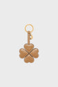 Tan leather porte-clé trèfle shaped like a four-leaf clover, each leaf resembling a heart, with white stitching and a gold keyring attached.