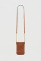 Brown suede and leather crossbody bag with a long strap and elegant bandoulière chaîne and gold chain accents, displayed against a plain white background.