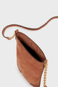 A brown suede crossbody bag with a gold bandoulière chaîne and leather strap is shown from above, displaying its open top and empty interior against a plain white background. This elegant porte-téléphone design showcases the refined texture of cuir velours for a timeless accessory.