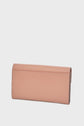 A light pink rectangular wallet in portefeuille cuir with a smooth texture, shown closed and standing on a white background—an accessoire élégant that perfectly complements any ensemble.
