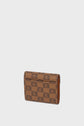 A brown portefeuille Gerard Darel with a checkered pattern featuring a repeating logo design, shown standing upright against a plain light gray background.