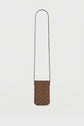 A small brown crossbody bag with a long strap and a checkered pattern in toile enduite monogrammée, featuring a convenient fermeture magnétique, displayed against a plain white background.