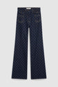 Dark blue taille haute wide-leg jeans with front patch pockets and an all-over repeating motif monogramme, laid flat on a white background.