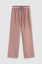Brown satin pajama pants with a white geometric honeycomb pattern, featuring a drawstring waist and relaxed wide-leg fit, laid flat on a white background—these pantalon marron satin pants offer both comfort and style, perfect for your limited edition loungewear collection.