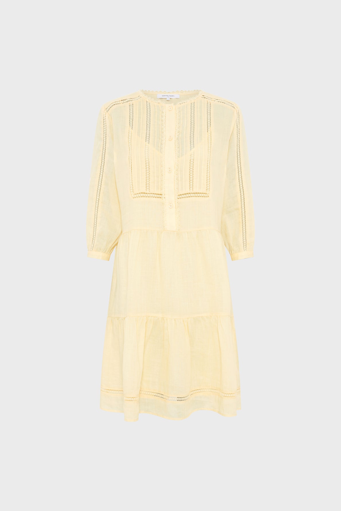 Light yellow, knee-length dress with three-quarter sleeves, front buttons, and tiered skirt. The fabric appears lightweight and features delicate lace or embroidered details on the bodice and sleeves.