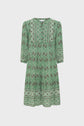 Green dress with a motif géométrique, three-quarter sleeves, and a loose, knee-length fit. This robe courte femme features intricate designs around the neckline, hem, and sleeve cuffs, creating a subtle style bohème perfect for any occasion.