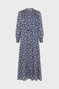 A long-sleeved, midi-length dress with a blue background and white floral print, featuring a V-neckline and a loose, flowing silhouette.