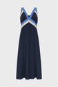 Sleeveless navy dress with a V-neckline. Crafted from coton tricolore, the dress features light blue and white chevron stripes across the chest and shoulders, creating a flattering contrast on a simple, knee-length A-line silhouette inspired by les années 50.