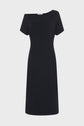 A simple, short-sleeve, knee-length black dress in jersey noir with a subtle asymmetrical neckline, displayed against a plain white background, exudes effortless élégance.
