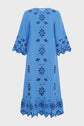 A blue knee-length dress with wide sleeves, floral cutout embroidery, and scalloped edges on the sleeves and hem. The dress has a loose, relaxed fit and features a symmetrical flower pattern that beautifully captures a look bohème with its intricate broderies florales.
