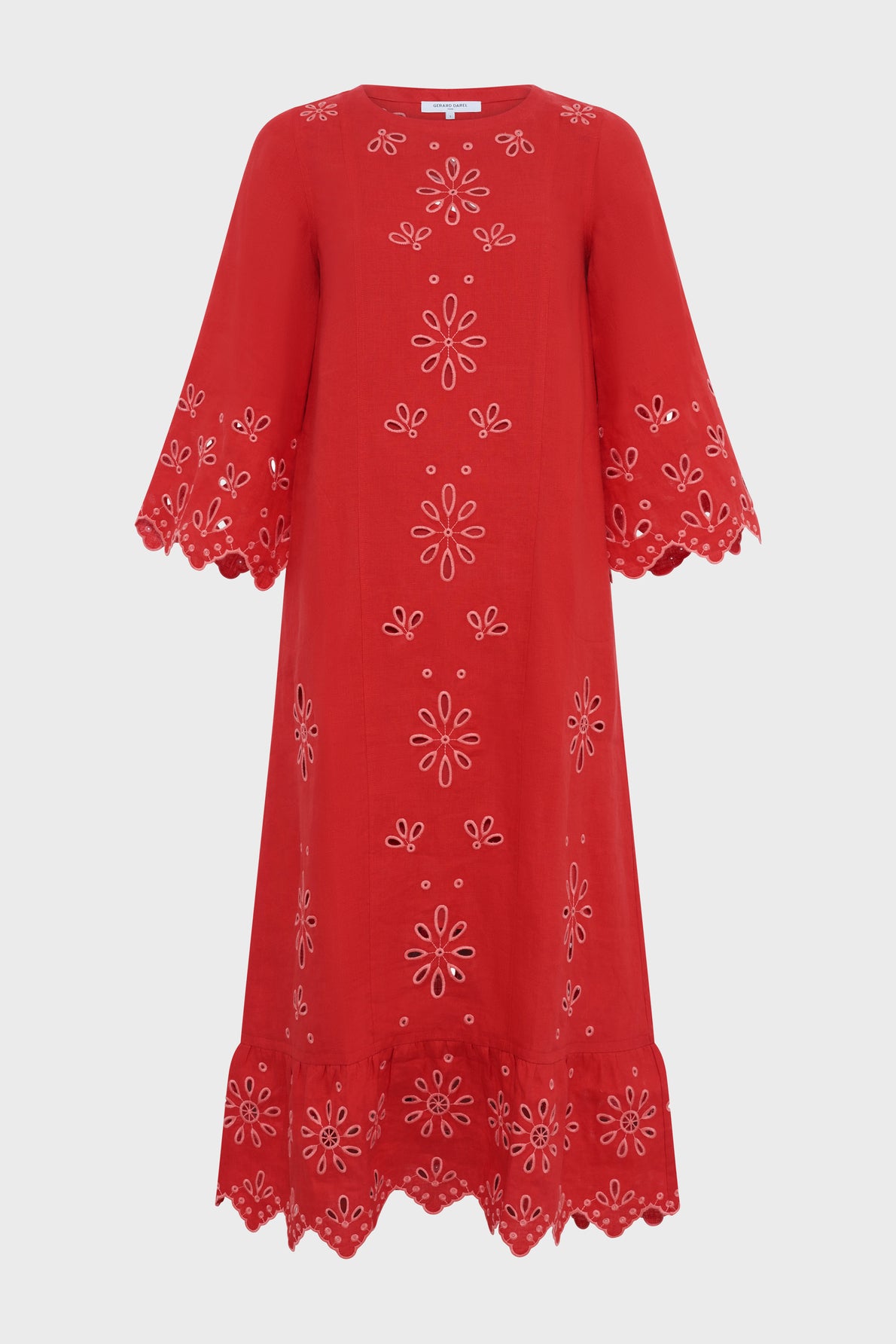A knee-length, bright red dress with broderies florales in eyelet embroidery. The dress features flared sleeves and a scalloped hem, both with matching embroidered patterns reminiscent of a robe bohème. The fabric appears lightweight and slightly textured.