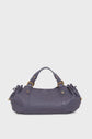 A purple leather sac à main cuir with gold hardware, two handles, and gathered side details, reminiscent of the elegant style of Vanessa Bruno’s iconic sacs 24H, displayed against a plain white background.