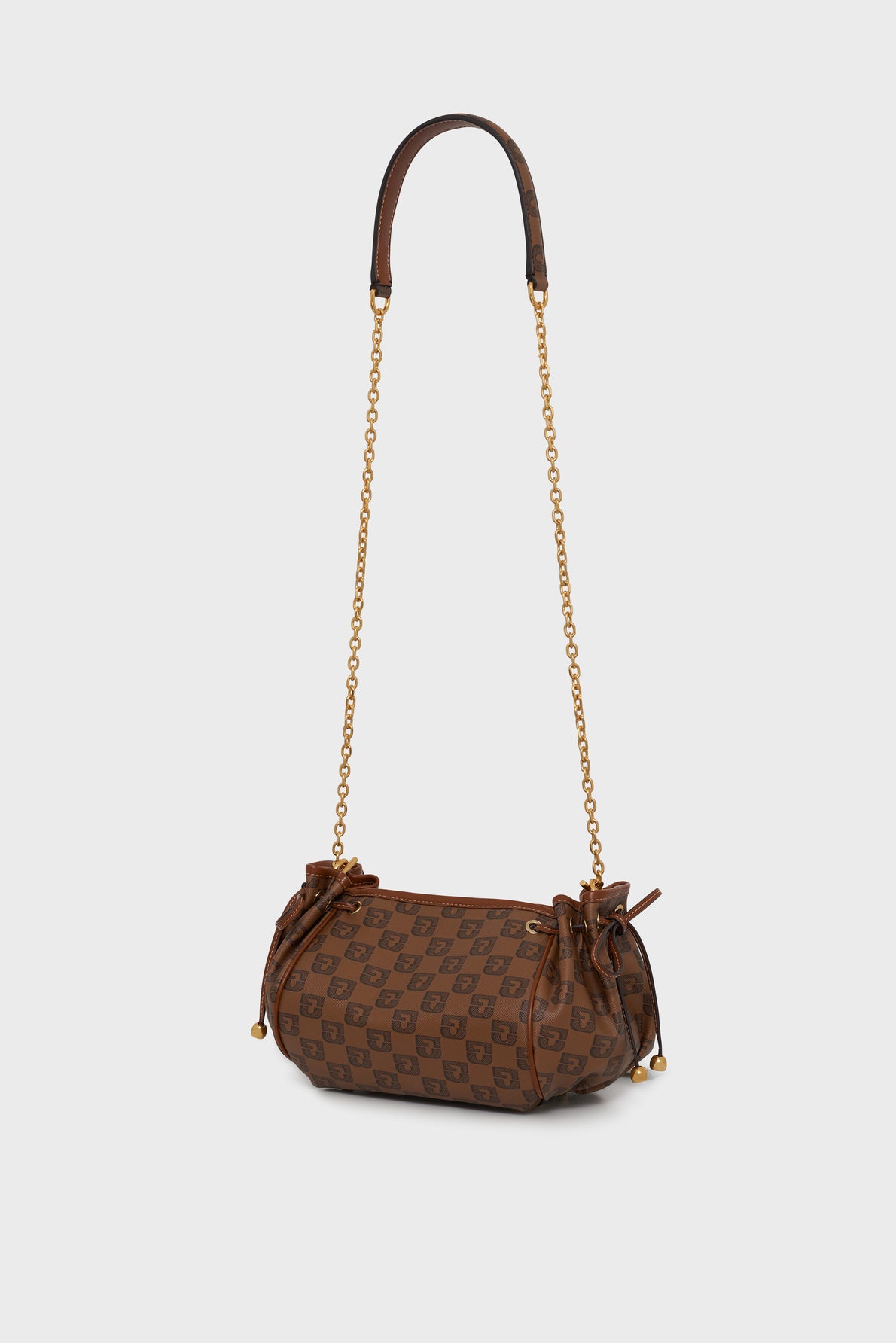 Brown cylindrical designer handbag with a checkered pattern, gold chain strap, leather handle, and small bows on the sides—this chic sac bandoulière features toile enduite monogrammée detailing, set against a plain light gray background.