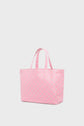 A light pink cabas monogrammé with two handles, featuring a subtle repeating pattern. This elegant sac LOLITA is shown against a plain, light background.