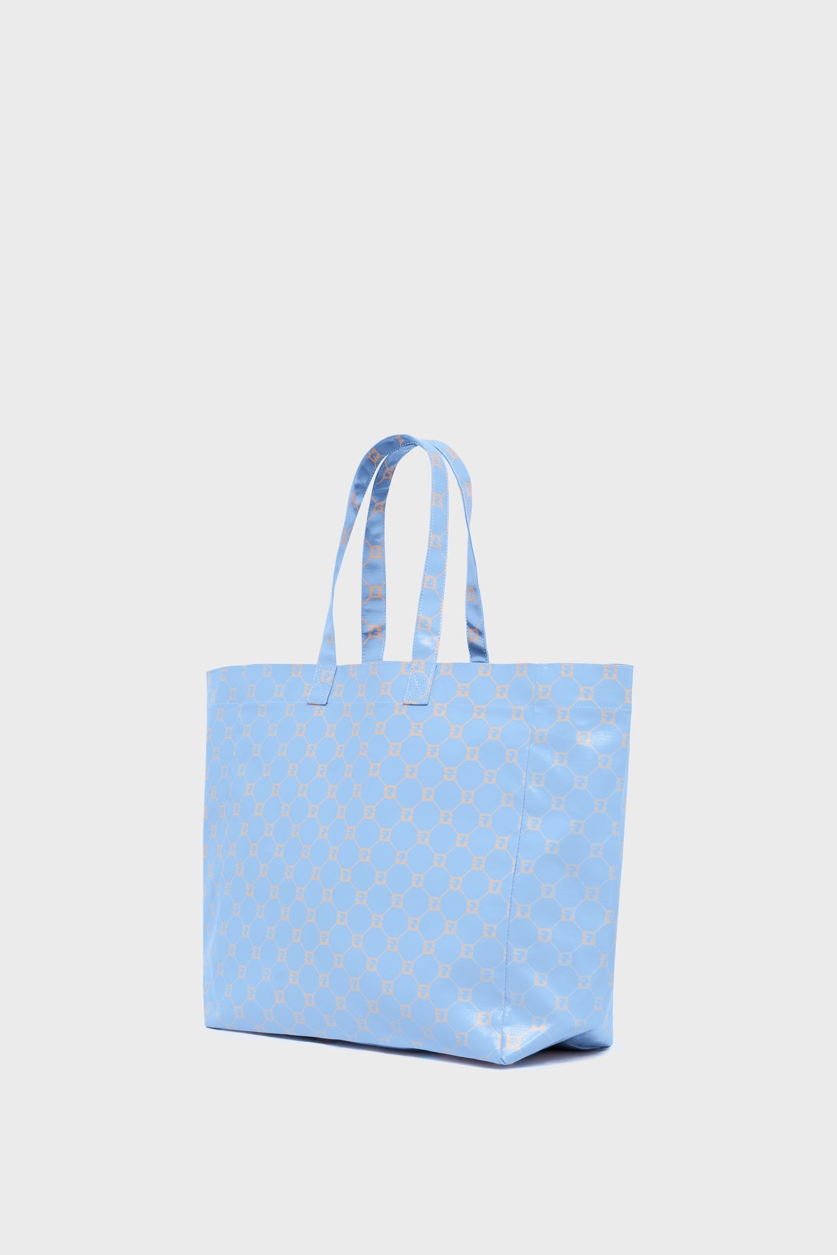 A light blue cabas en toile tote bag with two handles and a repeating geometric pattern in white, shown against a plain white background.