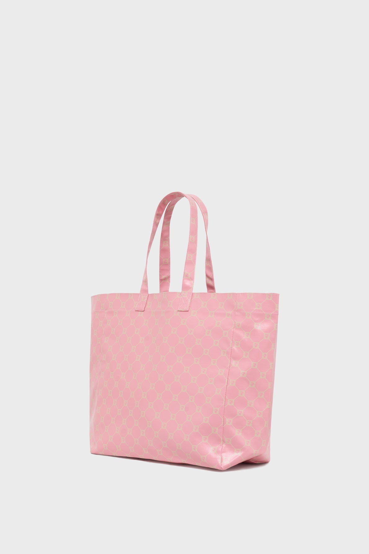 A large, light pink cabas en toile with two handles and a subtle repeating pattern, this elegant sac porté épaule is displayed against a plain white background.