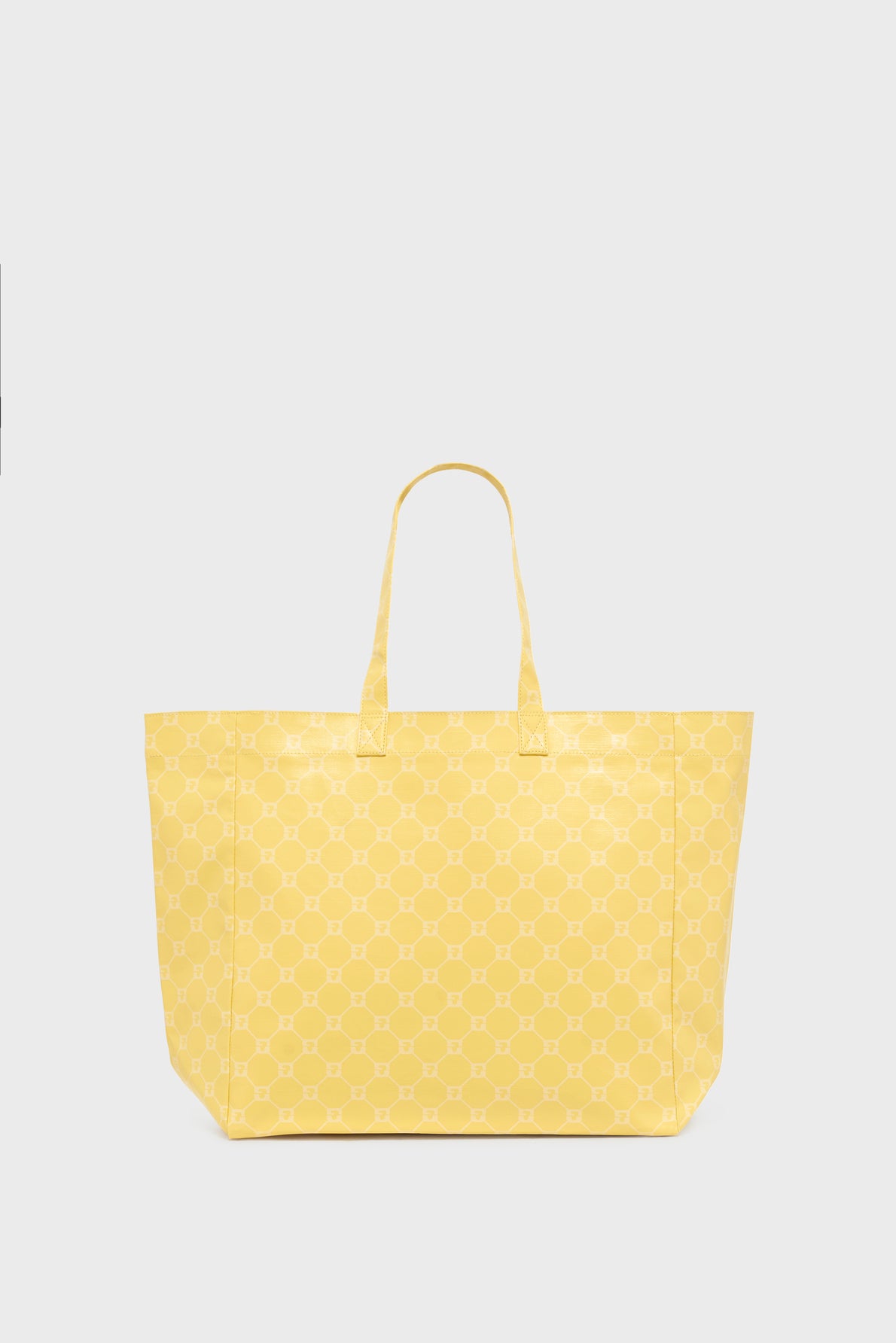 Yellow cabas monogrammé with two handles, featuring a subtle repeating geometric pattern, photographed against a plain light gray background.
