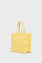 A yellow cabas monogrammé with light-colored geometric patterns, featuring two handles, is shown against a plain, light background.
