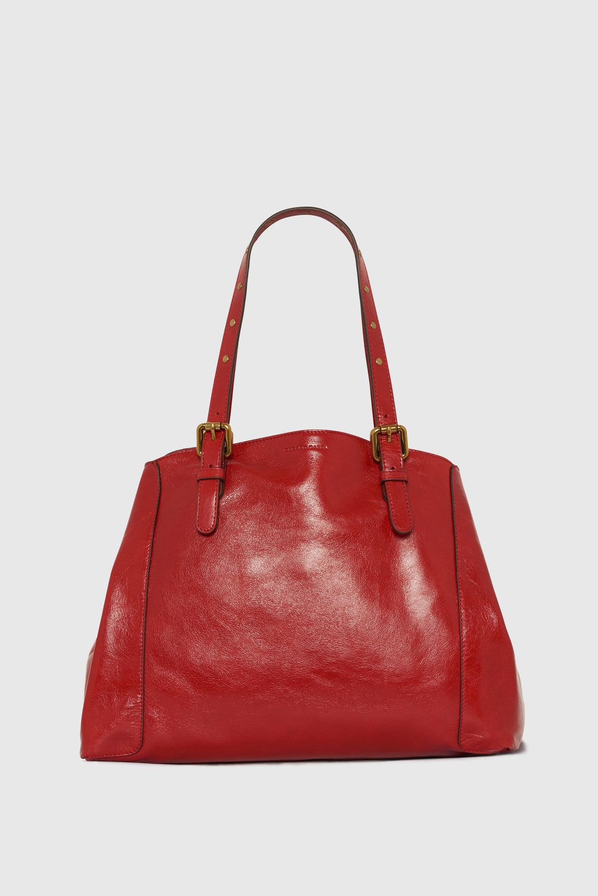A shiny red leather handbag with two adjustable shoulder straps and gold buckles, displayed against a plain light gray background.