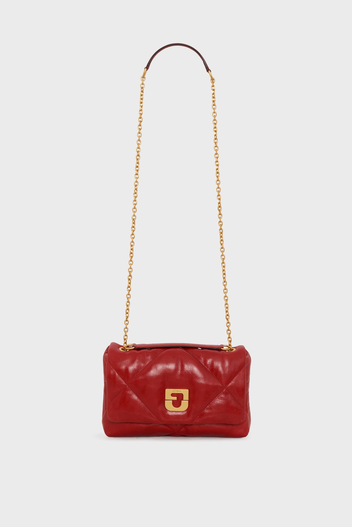 A red leather quilted sac bandoulière with a gold chain strap and a gold rectangular clasp, this pièce de créateur is displayed against a white background.