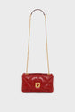 A red leather quilted sac bandoulière with a gold chain strap and a gold rectangular clasp, this pièce de créateur is displayed against a white background.