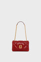A red cuir matelassé leather sac bandoulière featuring a gold chain strap and a gold rectangular clasp, displayed against a plain white background.