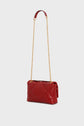A red sac bandoulière en cuir matelassé with a gold chain strap and a red leather handle, displayed against a plain light background.