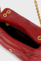 A close-up of a red cuir matelassé handbag with a gold chain strap, gold hardware, and a partially unzipped black interior pocket highlights this stunning pièce de créateur.