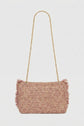 A rectangular pink woven handbag with fringe edges and a gold chain strap, crafted in raphia with remarkable savoir-faire artisanal, displayed against a plain white background.