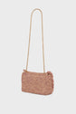 A small rectangular pink tweed sac bandoulière with fringe edges and a long gold chain strap, showcasing exquisite savoir-faire artisanal, displayed against a plain white background.