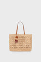 Beige woven straw tote bag with two brown handles and decorative multicolored tassels hanging from one handle, this cabas raphia sac artisanal exudes a panier chic vibe, set against a plain white background.