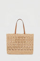 A woven straw tote bag with two brown leather handles, this sac artisanal features an open lattice design against a white background.