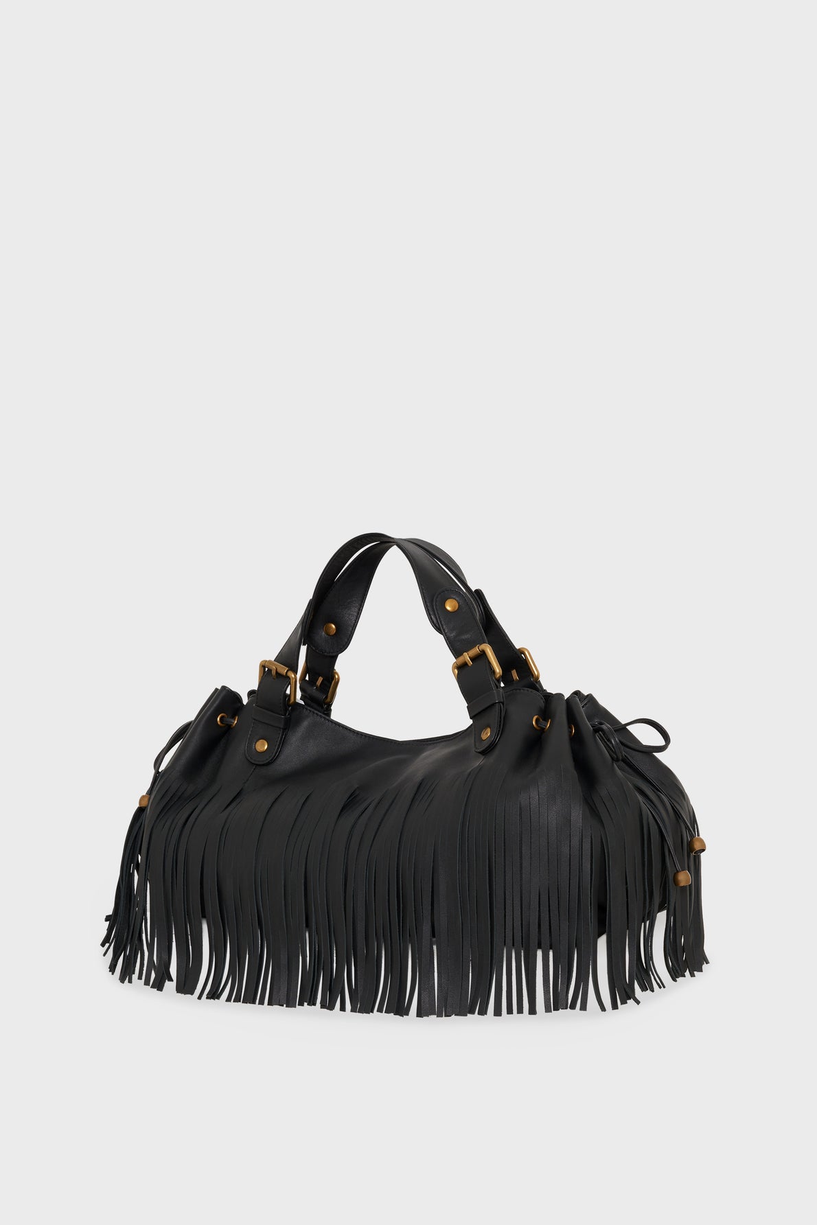 A black cuir de vachette noir sac à main frangé with long fringe detailing, gold buckle accents, and double handles, displayed against a plain white background.