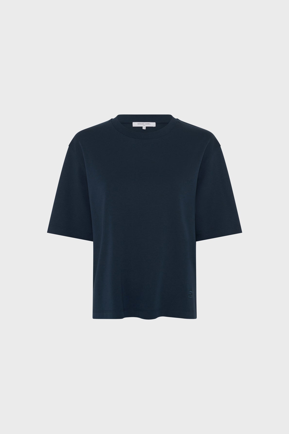 Plain navy blue short-sleeved T-shirt laid flat against a light gray background, featuring a classic crew neckline and a relaxed fit.