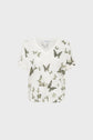 A white short-sleeve V-neck T-shirt featuring a pattern of green and black butterflies scattered across the front and sleeves.