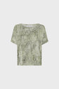A short-sleeve, green and gray snakeskin-patterned crop top is displayed on a plain white background.