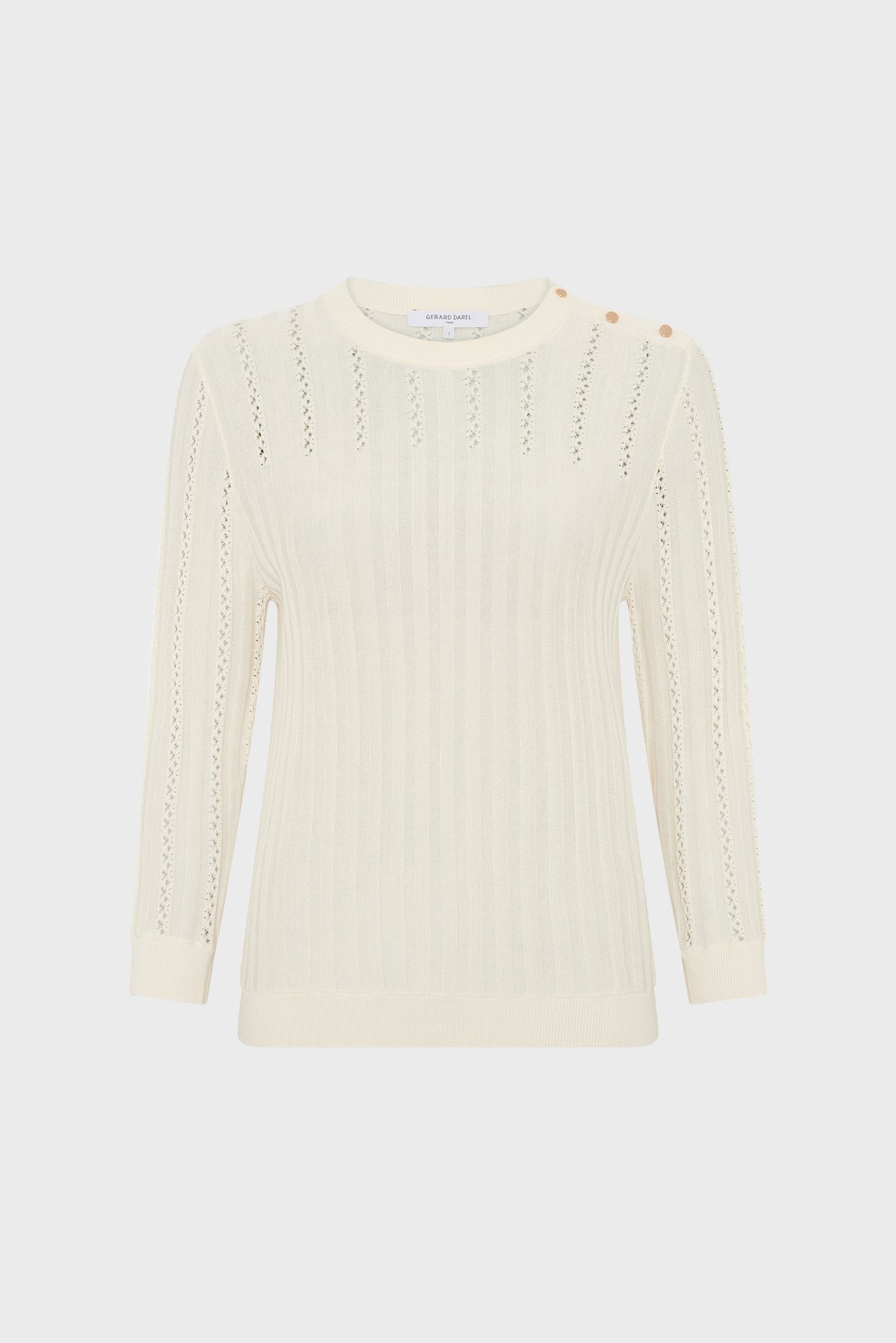 Cream-colored knit sweater with long sleeves, subtle vertical patterns, and three gold buttons on the left shoulder, displayed on a plain white background.