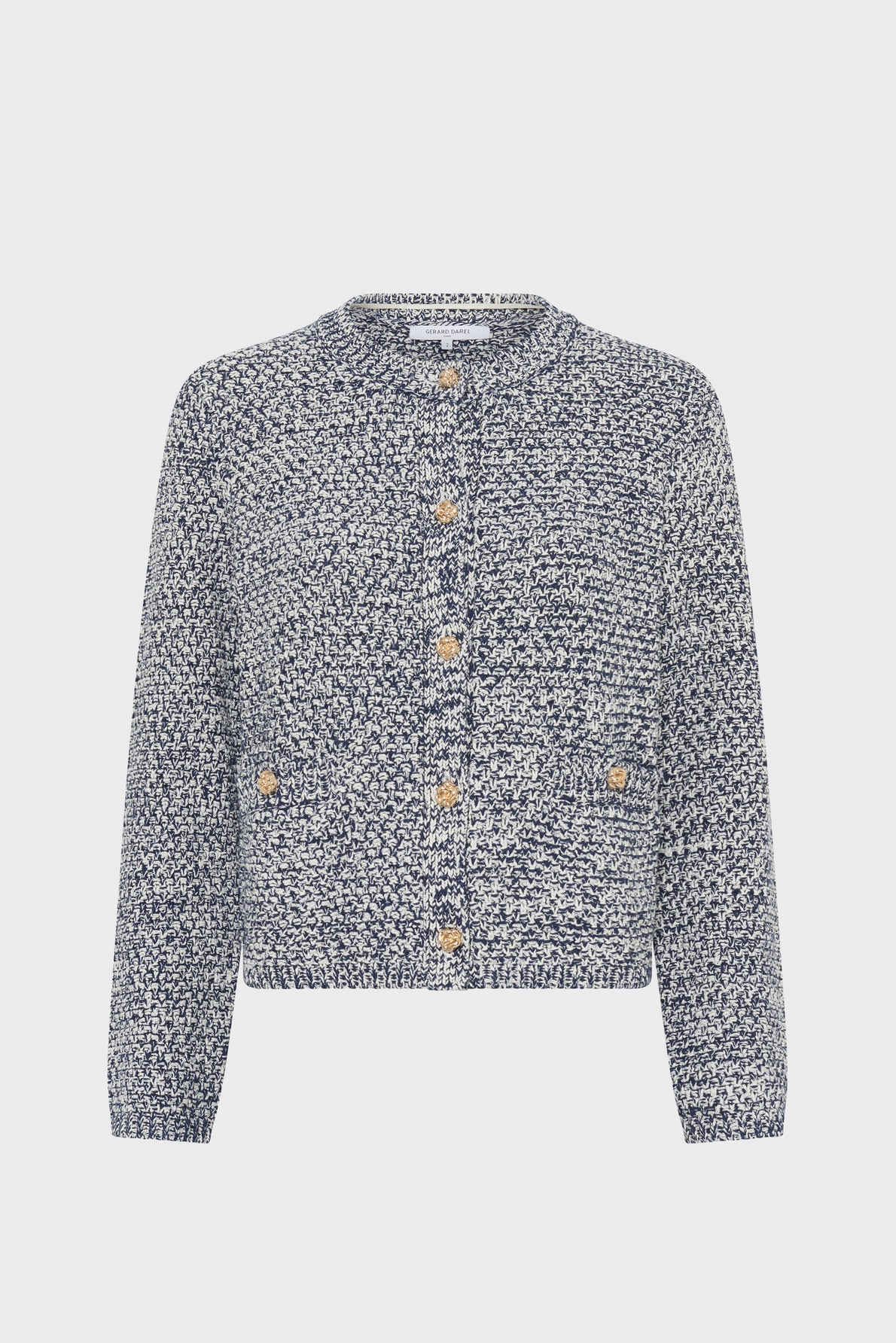 A gilet en coton chiné, this blue and white speckled knit cardigan features long sleeves, a round neckline, gold buttons down the front, and two small front pockets. Displayed on a plain white background, this gilet bleu blanc adds a touch of classic elegance to any outfit.