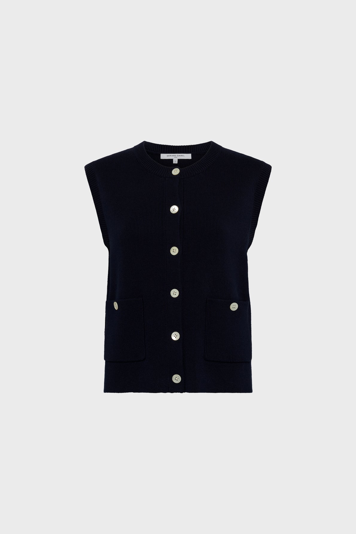 Sleeveless black knit vest with a round neckline, front button closure reminiscent of a classic gilet boutonné, and two front pockets, each with a button detail, displayed on a plain light gray background.